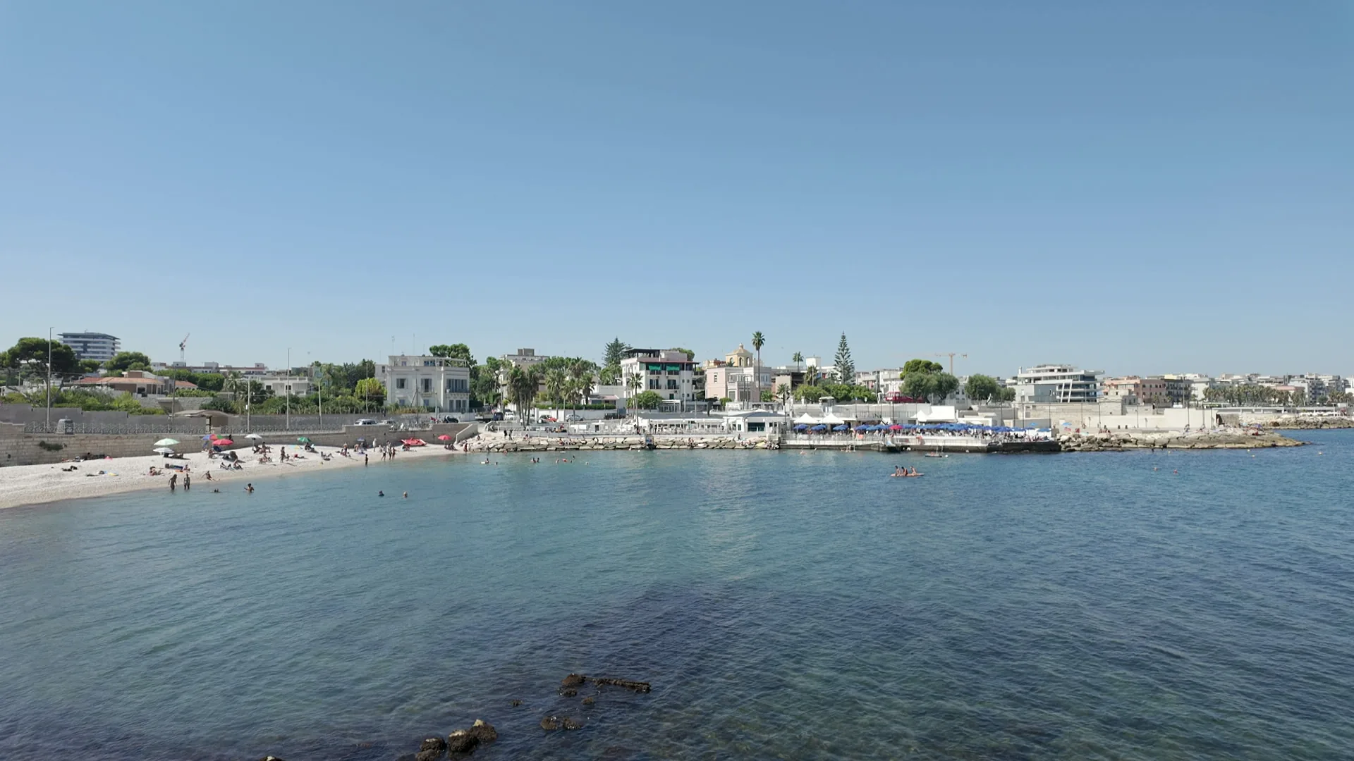 Il mare trasparente della baia di Colonna, a Trani, con la spiaggia e il lungomare